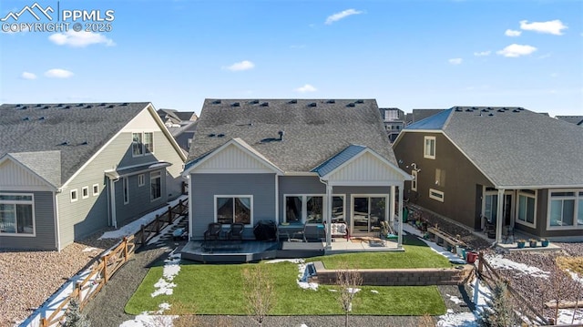 rear view of house featuring a wooden deck and a lawn