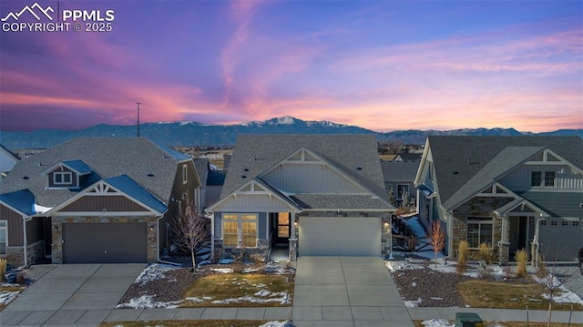 craftsman-style house featuring a garage and a mountain view