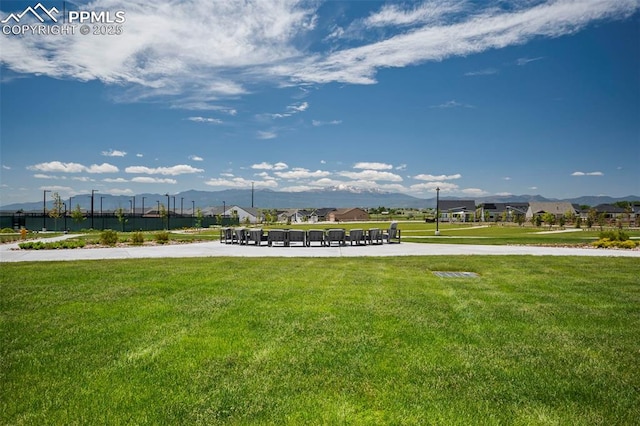 view of community featuring a lawn and a mountain view