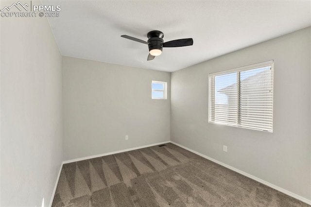 empty room with dark carpet and ceiling fan