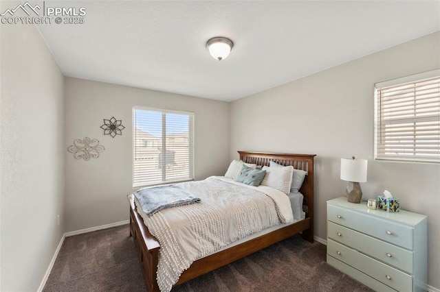 bedroom with dark colored carpet