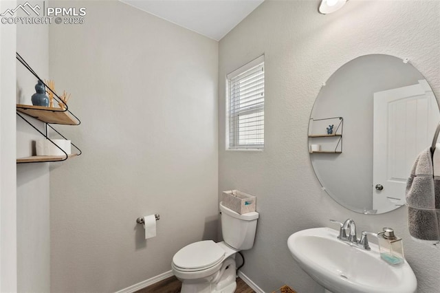 bathroom featuring toilet and sink