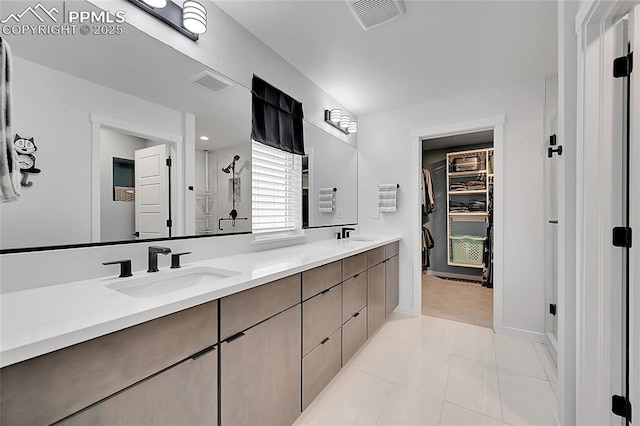 bathroom with tile patterned floors, vanity, and a shower with shower door