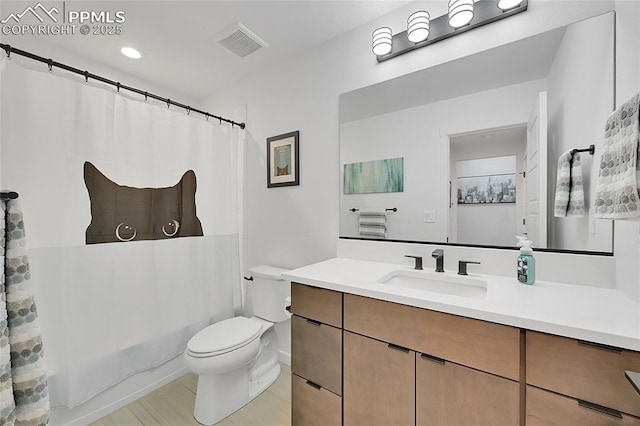 full bathroom featuring shower / tub combo, vanity, and toilet