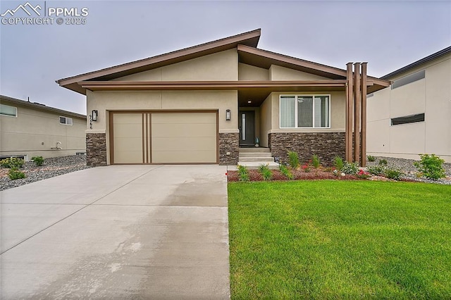 view of front of home featuring a front yard and a garage