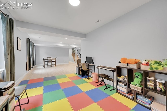 rec room with light hardwood / wood-style flooring