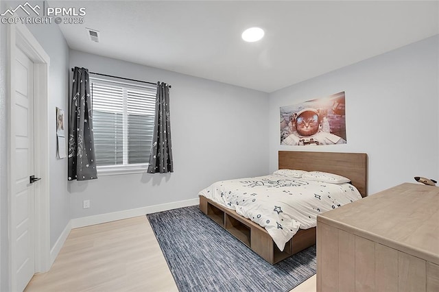 bedroom with hardwood / wood-style floors