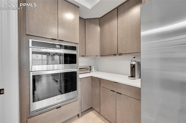 kitchen featuring backsplash and appliances with stainless steel finishes