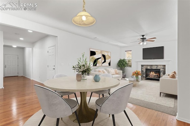 dining space featuring hardwood / wood-style flooring and ceiling fan