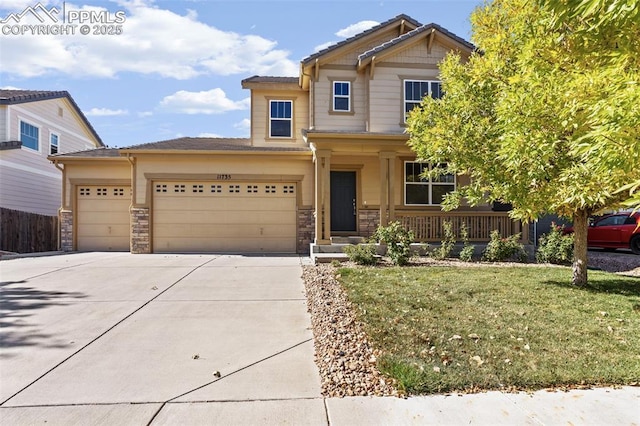 craftsman inspired home with a garage, a front yard, and a porch