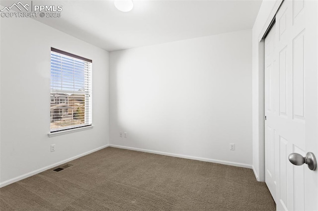 unfurnished bedroom with carpet floors and a closet