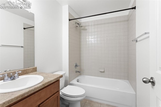 full bathroom featuring tiled shower / bath, vanity, toilet, and tile patterned flooring