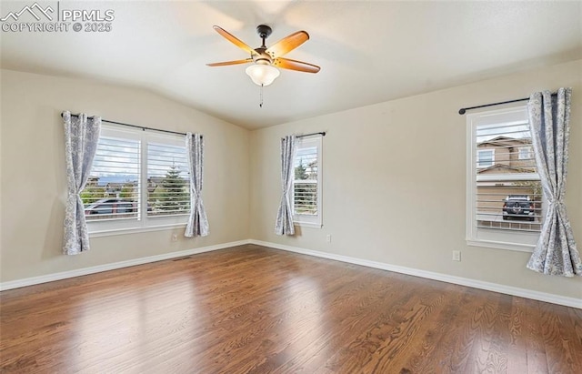 unfurnished room with ceiling fan, vaulted ceiling, and hardwood / wood-style flooring