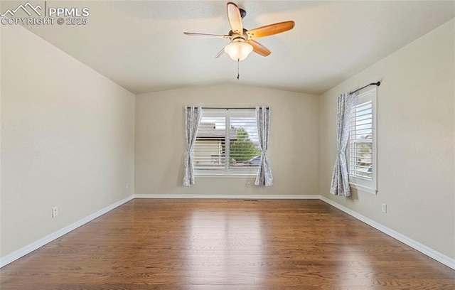 unfurnished room with hardwood / wood-style flooring, ceiling fan, and vaulted ceiling