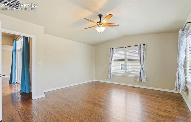 empty room featuring dark hardwood / wood-style flooring, ceiling fan, and lofted ceiling