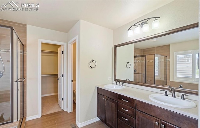 bathroom with vanity and a shower with shower door