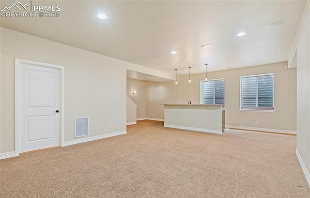 unfurnished living room with light carpet