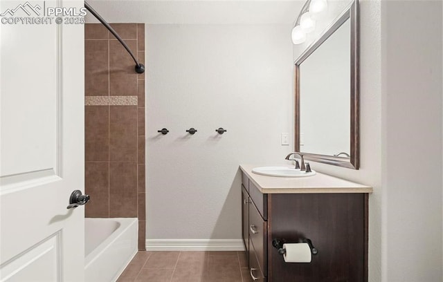 bathroom with tile patterned flooring, vanity, and tiled shower / bath combo