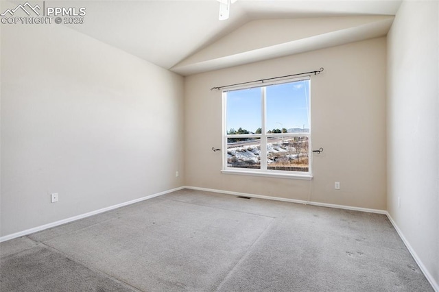 carpeted spare room featuring lofted ceiling