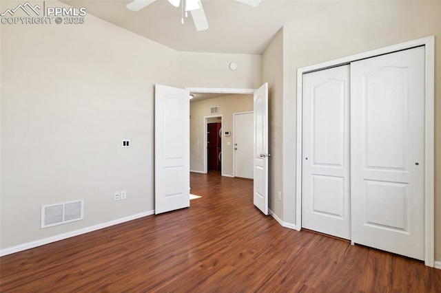 unfurnished bedroom featuring dark hardwood / wood-style flooring, a closet, and ceiling fan