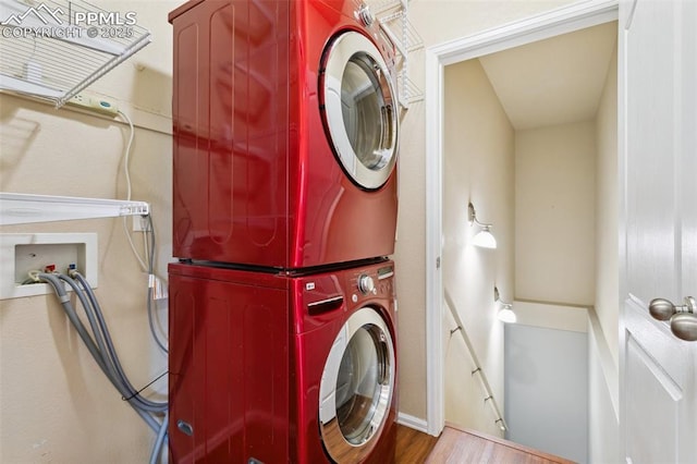 washroom featuring stacked washer / drying machine and light hardwood / wood-style floors