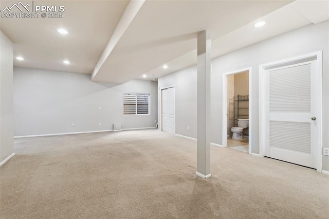 basement featuring light carpet