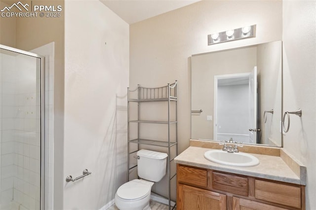 bathroom with walk in shower, vanity, and toilet