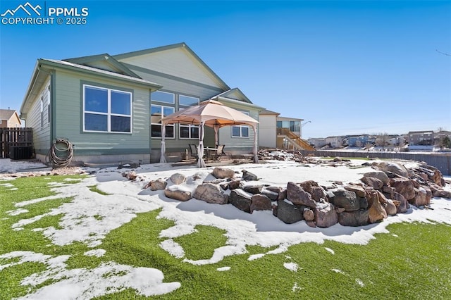 snow covered property with a patio