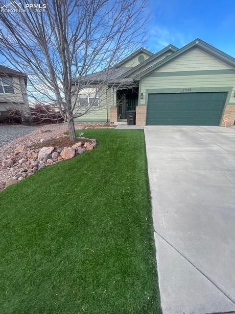 single story home with a garage and a front lawn