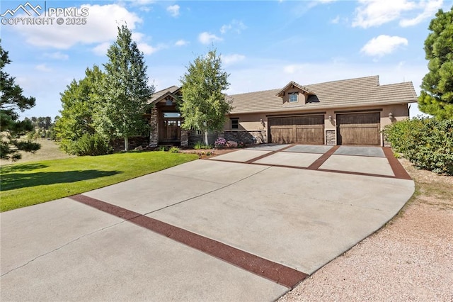 view of front of property featuring a garage and a front lawn