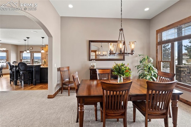 dining room featuring a chandelier and light carpet