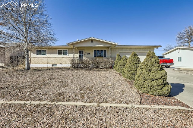 single story home with a garage and covered porch