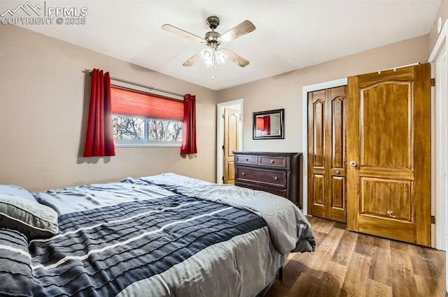 bedroom with a closet, ceiling fan, and light hardwood / wood-style flooring