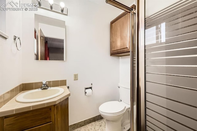 bathroom featuring tile patterned floors, vanity, and toilet