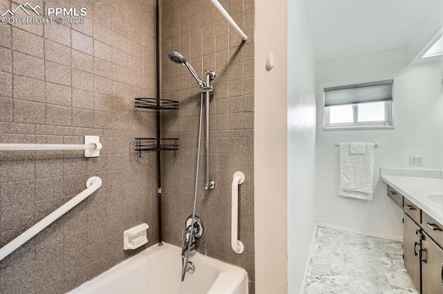 bathroom with tiled shower / bath combo and vanity