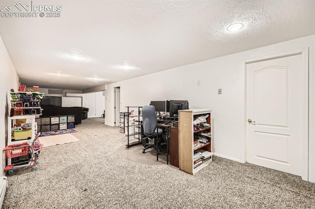 carpeted office with a textured ceiling and a baseboard heating unit