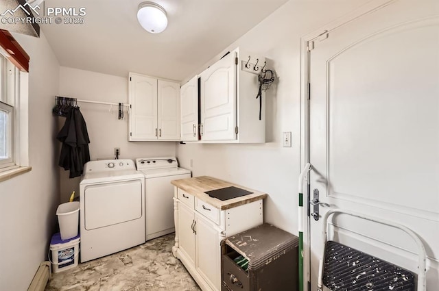 laundry area featuring cabinets, a baseboard radiator, and washer and clothes dryer