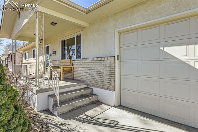 doorway to property with a garage