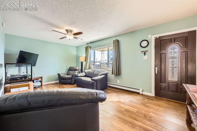 living room featuring a baseboard radiator, a textured ceiling, ceiling fan, and light hardwood / wood-style flooring