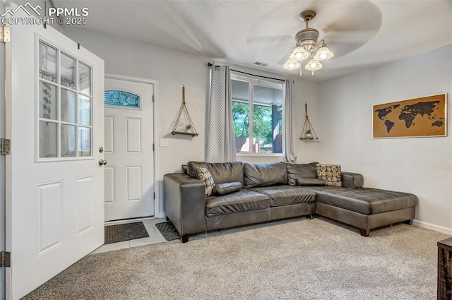 carpeted living room with ceiling fan