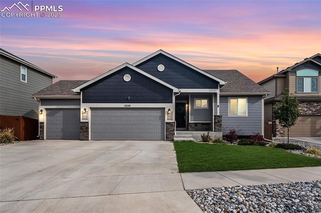 view of front of house featuring a garage and a yard