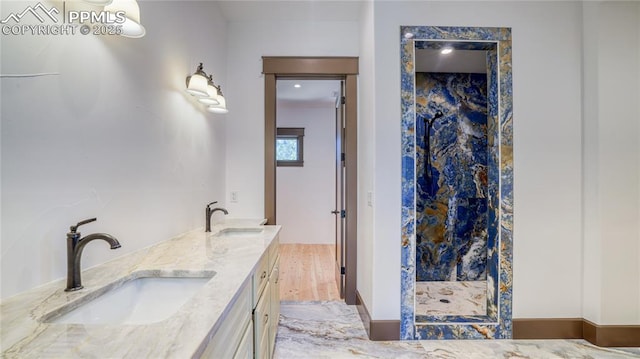 bathroom with a shower, hardwood / wood-style floors, and vanity