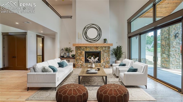 interior space with a fireplace, a high ceiling, and hardwood / wood-style flooring