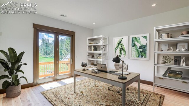 office space with french doors and light hardwood / wood-style flooring