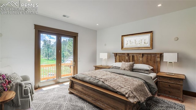 bedroom with light hardwood / wood-style floors and access to outside