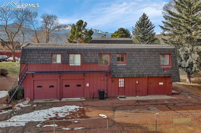 exterior space featuring a garage and a mountain view