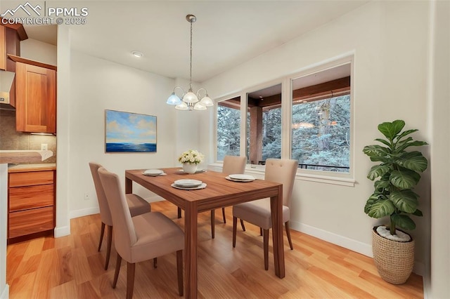 dining area featuring a chandelier and light wood-type flooring