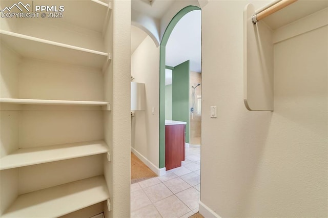 spacious closet with light tile patterned floors