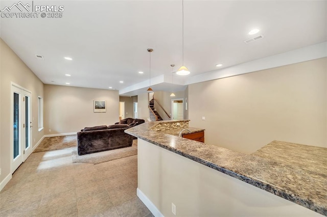 kitchen with pendant lighting and dark stone countertops