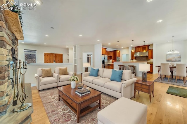 living room with light hardwood / wood-style floors and a chandelier